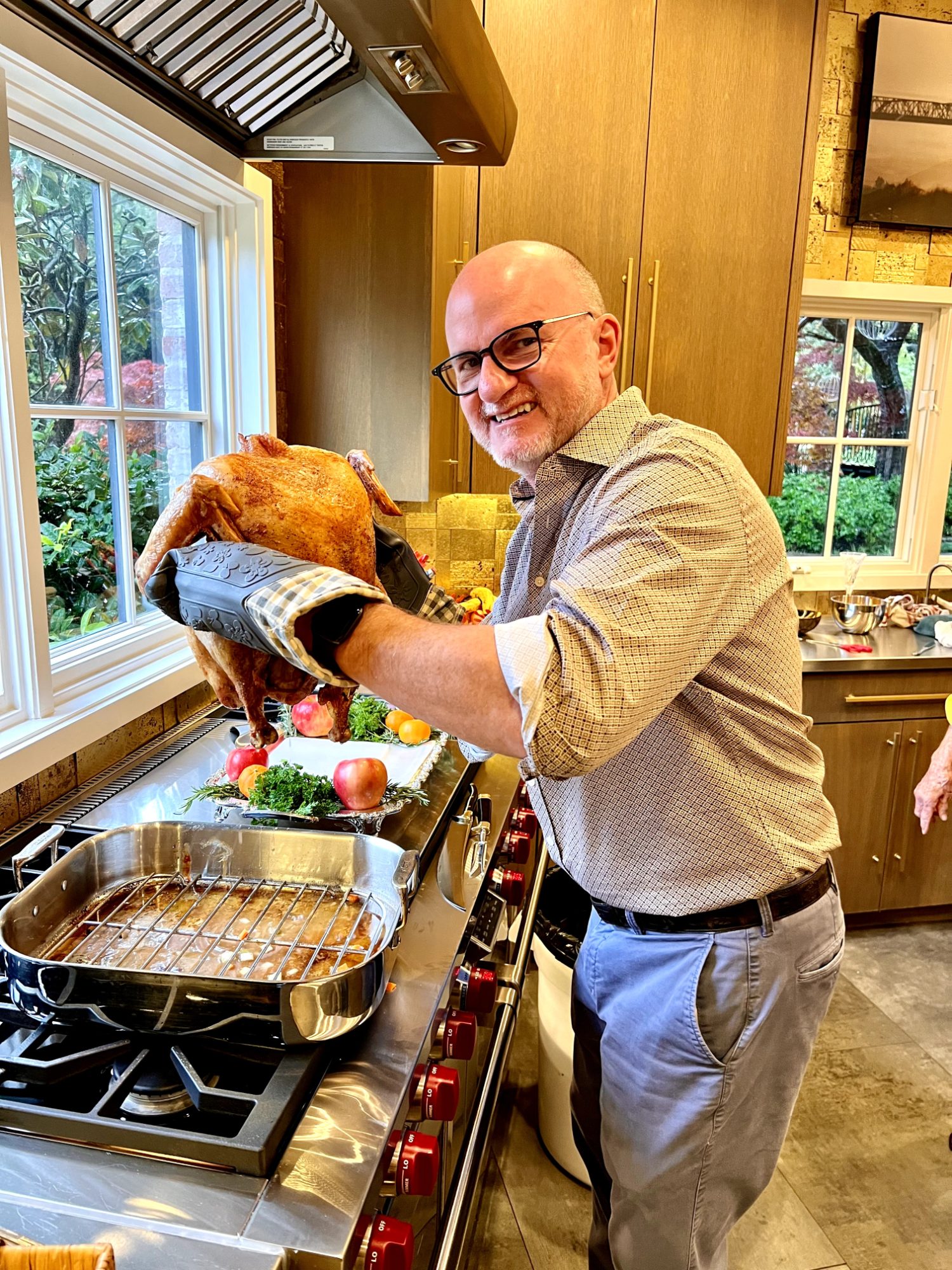 Roasted Thanksgiving turkey coming out of the oven in a home kitchen